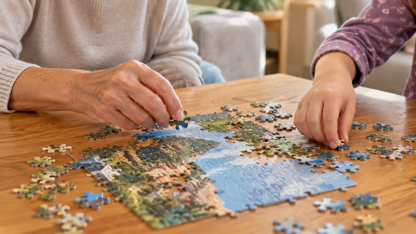 A hand placing a small puzzle piece on a table while a child watches